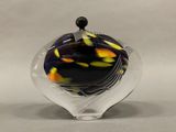a glass vase with a black and yellow design on it