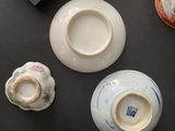 many different types of vases and bowls on the table