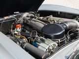 a close up of a car ' s engine with its hood open