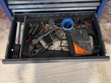 a tool box with tools inside of it on the floor