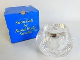 a small glass bowl sitting next to a blue box