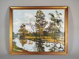 une image représentant un tableau représentant une rivière et des arbres, dans un cadre doré