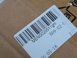 a box with a barcode on it and a pair of scissors in it