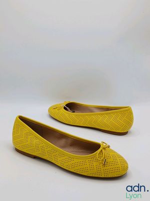 a pair of yellow women ' s shoes on a white background