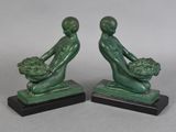 pair of art deco bookends of a man and a woman holding a basket of flowers