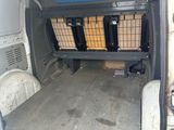 a small van with a basket in the back of it