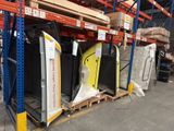 many pieces of furniture in the warehouse on the pallets