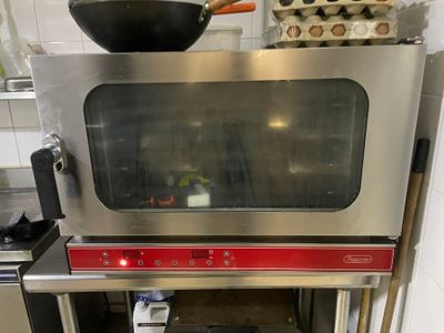 an image of a kitchen with a stove and a microwave