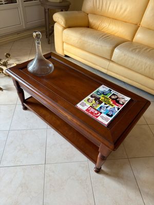 a coffee table with a magazine on it in a living room