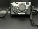 a black camera with a black strap on a black table