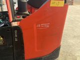a forklift that is sitting in a warehouse
