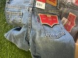 a box of jeans that are sitting on the grass