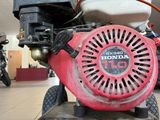 a close up of a honda engine on a cart