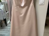 the dress is hanging on a hanger in front of a mirror