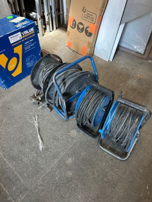 a blue cart with a bunch of wires on the floor
