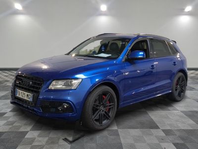 the blue audi suv is parked on a checkered tile floor