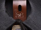 the inside of a black leather bag with a brown leather strap
