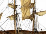 a model of a ship with sails on a white background