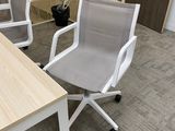a desk with two chairs and a computer on it