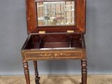a small wooden table with a mirror in it