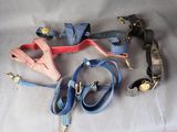 a lot of dog leashes and collars on a table