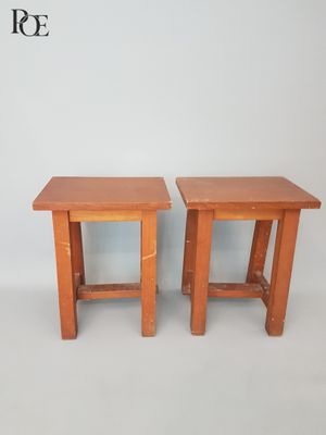 pair of wooden side tables with legs and a shelf on each side