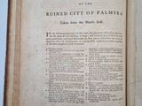 an open book with a picture of a view of the ruined city of palmyra