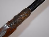 a close up of a rifle with a wooden handle
