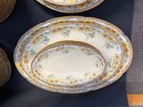 many plates and bowls that are on a table
