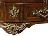 a wooden chest of drawers with gold decorations on it