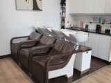 a picture of a salon room with two chairs and a sink