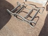 a chair that is sitting on the ground in front of a bench