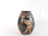 a vase that has a picture of a man playing a game of tennis