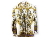 an image of a jacket hanging on a hanger on a white wall