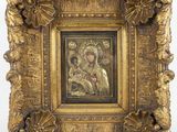 an ornate gold frame with a painting of the virgin and child