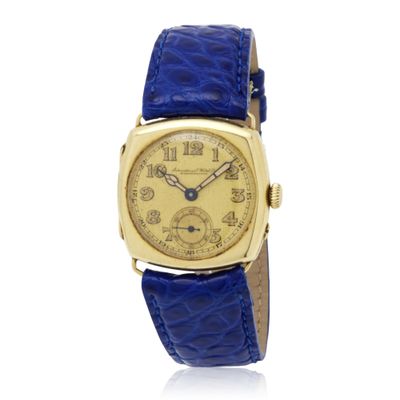 an image of a gold wrist watch with blue leather strap
