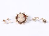 three pieces of jewelry including a ring, earrings, and a broochle