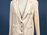 white jacket on a mannequin stand against a blue background