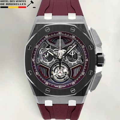 un gros plan d'une montre posée sur une surface blanche, avec un bracelet rouge