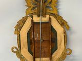 a wall mounted mirror with a violin on it