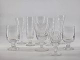 six wine glasses sitting on a table with a white background