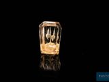 an image of a glass bottle filled with liquid sitting on top of a black surface