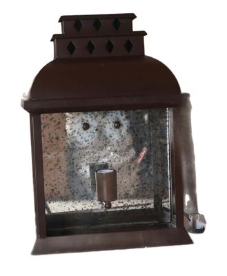 a brown lantern with a teddy bear inside of it