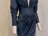 the mannequin is wearing a black dress with long sleeves
