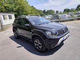 the front view of a black dacia parked in a parking lot