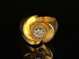 an image of a gold and diamond ring on a black surface