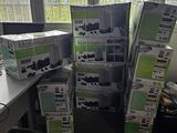 a pile of boxes sitting on a desk in front of a window