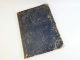 an old book on a white table with a white background