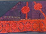 an orange and purple piece of cloth with a design on it