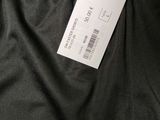 a close up of the back of a black pants with a tag on it